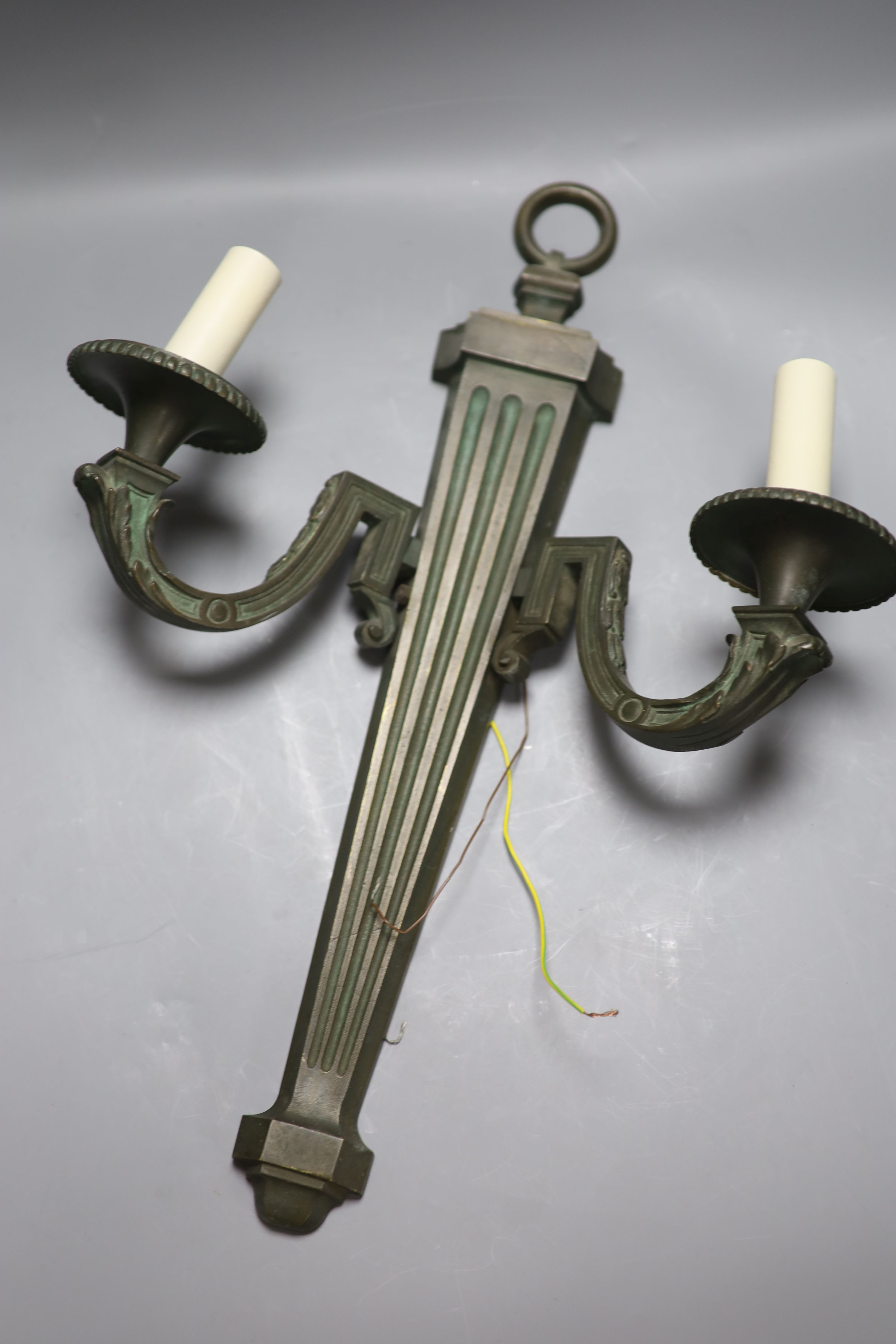 A pair of bronze two branch wall lights, length 52cm